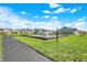 Community playground with modern play structures, a path, and open green spaces at 6827 Fallen Leaf Dr, Whitestown, IN 46075