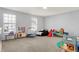 Bright playroom featuring multiple windows, a variety of toys, and ample space for fun at 6827 Fallen Leaf Dr, Whitestown, IN 46075