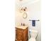 Charming half bathroom featuring a unique vanity, decorative mirror, and elegant lighting fixtures at 7140 Avalon Trail Dr, Indianapolis, IN 46250