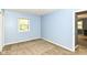 This spacious bedroom features light blue walls, neutral carpet, and a window for natural light at 7140 Avalon Trail Dr, Indianapolis, IN 46250