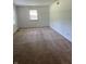 Neutral bedroom with a window providing natural light and carpeted flooring throughout at 7140 Avalon Trail Dr, Indianapolis, IN 46250
