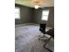 This bedroom features plush carpeting, neutral walls, a ceiling fan, and windows providing ample natural light at 7140 Avalon Trail Dr, Indianapolis, IN 46250
