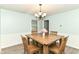 Cozy dining area with a wooden table set for four, complemented by natural light and a chandelier at 7140 Avalon Trail Dr, Indianapolis, IN 46250