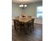 Inviting dining room with hardwood floors, a chandelier, and ample natural light at 7140 Avalon Trail Dr, Indianapolis, IN 46250