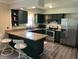 Modern kitchen featuring stainless steel appliances, granite countertops, and a convenient breakfast bar at 7140 Avalon Trail Dr, Indianapolis, IN 46250