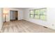 Bright, carpeted living room featuring a large window for natural light and a glimpse of the outdoors at 7140 Avalon Trail Dr, Indianapolis, IN 46250