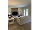 Cozy living room featuring a brick fireplace, built-in shelving, and a french door to the exterior at 7140 Avalon Trail Dr, Indianapolis, IN 46250