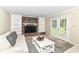Bright living room boasts a brick fireplace, built-in shelves, and access to the outdoors at 7140 Avalon Trail Dr, Indianapolis, IN 46250