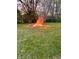 This backyard has a fire pit with a burning chair at 728 W 300 N, Anderson, IN 46011