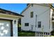 Showing a side view of the house and the detached garage with updated lighting at 728 W 300 N, Anderson, IN 46011