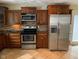 A close up of a kitchen, featuring stainless steel appliances and wood cabinetry at 728 W 300 N, Anderson, IN 46011