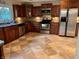 This kitchen has wood cabinets, stainless steel appliances and a tile backsplash at 728 W 300 N, Anderson, IN 46011