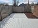A fenced-in backyard area featuring a wooden deck, a brick wall, and a storage unit at 7368 Country Brook Dr # 7368, Indianapolis, IN 46260