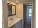 Bathroom featuring updated vanity and faucet, with a mirror and view to a bedroom at 7368 Country Brook Dr # 7368, Indianapolis, IN 46260