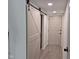 Charming hallway features a sliding barn door and recessed lighting at 7368 Country Brook Dr # 7368, Indianapolis, IN 46260