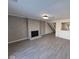 Spacious living room with a decorative fireplace, modern flooring, and an open layout to the staircase at 7368 Country Brook Dr # 7368, Indianapolis, IN 46260