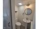 Updated half bathroom with modern fixtures, a pedestal sink, and a sliding barn door at 7368 Country Brook Dr # 7368, Indianapolis, IN 46260