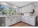 Bright kitchen with white cabinetry, quartz countertops, and stainless steel appliances overlooking the backyard at 7425 E 300 S, Whitestown, IN 46075