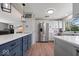 Open-concept kitchen with stainless steel appliances, island with seating, and backyard views at 7425 E 300 S, Whitestown, IN 46075