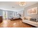 Bright main bedroom suite with hardwood floors, chaise lounge, and a king-sized bed at 7425 E 300 S, Whitestown, IN 46075