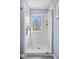 A luxurious shower featuring marble tile and a window that allows natural light to flood the space at 7425 E 300 S, Whitestown, IN 46075