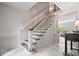 Classic staircase with wood and white trim, natural light, and entryway console table at 7425 E 300 S, Whitestown, IN 46075