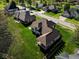 Aerial view of the property showcasing the sprawling lawn, neighboring homes, and street at 8188 Spring Valley Dr, Plainfield, IN 46168