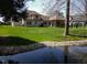 Scenic backyard view with a tranquil pond and beautifully landscaped surroundings at 8188 Spring Valley Dr, Plainfield, IN 46168