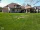 Expansive backyard with lush green lawn, mature trees, and a charming covered patio at 8188 Spring Valley Dr, Plainfield, IN 46168