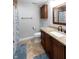 Bathroom with granite countertops, a vanity, cabinet, toilet, shower with stylish curtain, and blue rugs at 8188 Spring Valley Dr, Plainfield, IN 46168