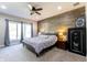 This primary bedroom features a king bed, wood accent wall, and a window with beautiful natural light at 8188 Spring Valley Dr, Plainfield, IN 46168