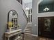 Foyer showcasing a staircase with wrought iron railings and a decorative mirror at 8188 Spring Valley Dr, Plainfield, IN 46168