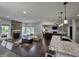 Open-concept living space with a stone fireplace, comfortable seating, and scenic views at 8188 Spring Valley Dr, Plainfield, IN 46168