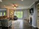 Inviting living room with a fireplace, built-in shelving, and backyard views at 8188 Spring Valley Dr, Plainfield, IN 46168