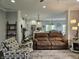 Inviting living room featuring plush seating, stylish decor, and an open floor plan leading to the kitchen at 8188 Spring Valley Dr, Plainfield, IN 46168