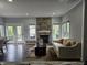 Cozy living room with fireplace, comfortable couch, and plenty of natural light at 8188 Spring Valley Dr, Plainfield, IN 46168