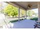 Inviting outdoor porch with ceiling fan and picturesque views of the lush backyard and pond at 8188 Spring Valley Dr, Plainfield, IN 46168