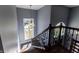 Stairway with chandelier, wood steps, and a railing with decorative metal work at 8188 Spring Valley Dr, Plainfield, IN 46168
