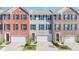 Charming townhome with brick facade, two-car garage, and manicured landscaping at 9014 Ramapo Dr, Fishers, IN 46038