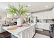 Open kitchen boasts an island with seating, stainless steel appliances, and seamless flow to the dining area at 9014 Ramapo Dr, Fishers, IN 46038