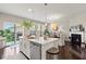 Kitchen island boasts a sink and dishwasher, with open access to the dining room and outside deck at 9014 Ramapo Dr, Fishers, IN 46038
