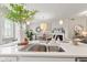Kitchen island boasts a sink and faucet, and it connects the kitchen to the dining room at 9014 Ramapo Dr, Fishers, IN 46038