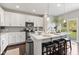 Bright kitchen with white cabinets, quartz countertops, stainless appliances, and island with seating at 9014 Ramapo Dr, Fishers, IN 46038