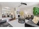Open-concept living room with hardwood floors, fireplace, and comfortable seating area at 9014 Ramapo Dr, Fishers, IN 46038
