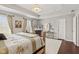 Spacious main bedroom features tray ceilings, warm wood floors, and a seating area at 9014 Ramapo Dr, Fishers, IN 46038