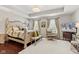 Serene main bedroom with tray ceilings, a sitting area, and large windows at 9014 Ramapo Dr, Fishers, IN 46038
