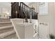 Staircase featuring carpeted steps, dark wooden railing, and decorative touches at 9014 Ramapo Dr, Fishers, IN 46038