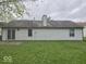 Rear exterior featuring grey siding, a sliding glass door, and a well-maintained lawn at 9118 Lansburgh Ct, Indianapolis, IN 46234