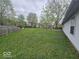 Expansive backyard with lush green grass and mature trees, ideal for outdoor activities at 9118 Lansburgh Ct, Indianapolis, IN 46234