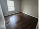 This bedroom features hardwood-style flooring and a bright window allowing for natural light at 9118 Lansburgh Ct, Indianapolis, IN 46234